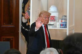 US President Donald Trump waves as he leaves after speaking about investing in America, at the White House in Washington, DC, on April 30, 2025
